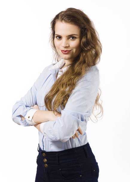 Portrait of young woman dressed in blue shirt posing on white background - Photo, image