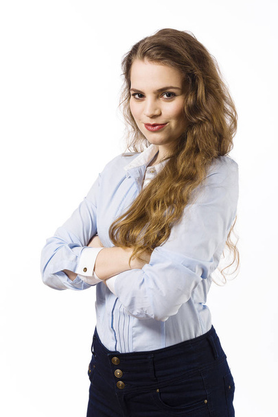 Portrait of young woman dressed in blue shirt posing on white background - Фото, изображение