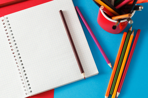 Notebook and pencils lie on colored paper. - Fotografie, Obrázek