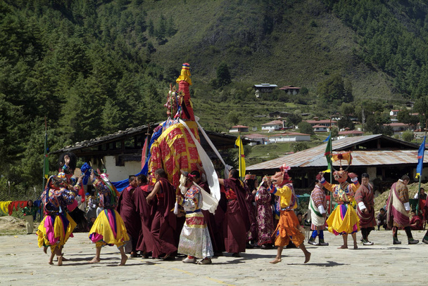 Haa, Bhutan - Septembember 21, 2007: Dancers with mask and monks by religious ceremony named Tshechu perform the Dance of Raksha Mangam - Photo, Image