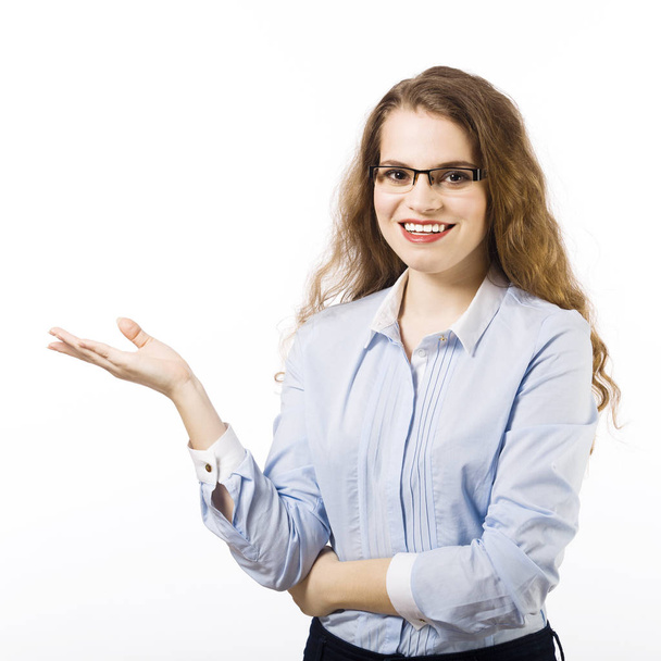 Portrait of young woman in glasses dressed in blue shirt posing on white background  - Foto, immagini