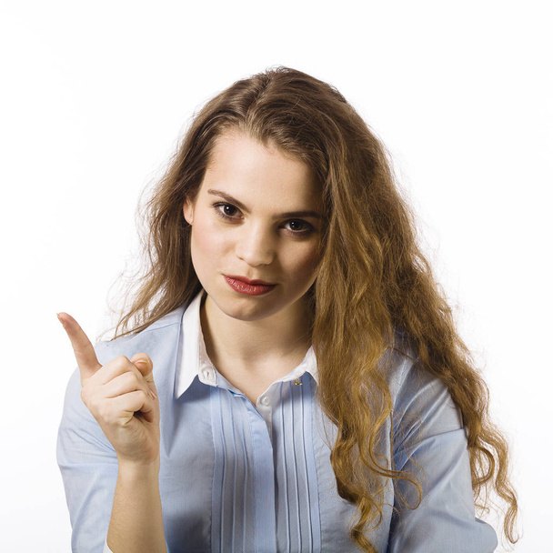 Portrait of young woman dressed in blue shirt posing on white background - Photo, Image