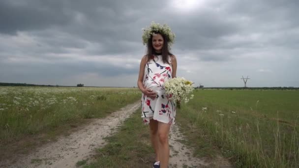カモミールの花の花束と妊娠中の女性. - 映像、動画