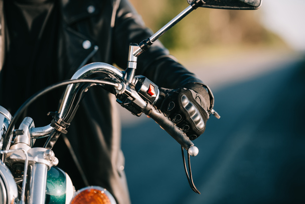 cropped view of biker sitting on classic motorcycle - Fotoğraf, Görsel