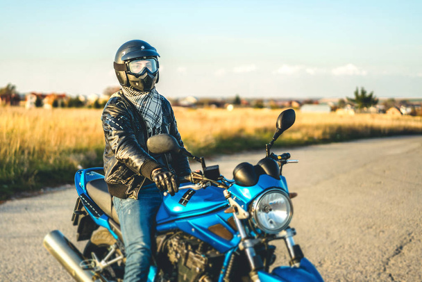Biker in crash helmet on sport motorcycle on road  - Fotografie, Obrázek