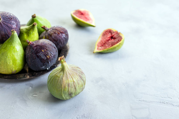green and blue figs on a gray stone background, concept, copy space - Valokuva, kuva