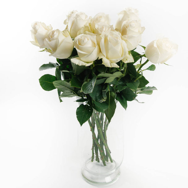 Kimppu upea valkoisia ruusuja valkoisella taustalla
 - Valokuva, kuva