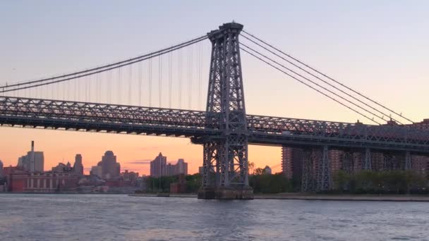 Lage hoek View, Close Up: Cruisen langs de East River naar Williamsburg Bridge met uitzicht op residentiële gebouwen, blokken van flats, appartement torens en wolkenkrabbers op de Lower East Side van Manhattan - Video