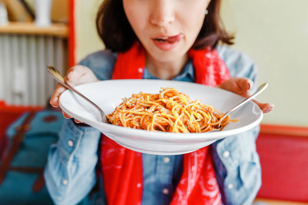 Young woman eating traditional italian pasta in local restaurant - Photo, Image