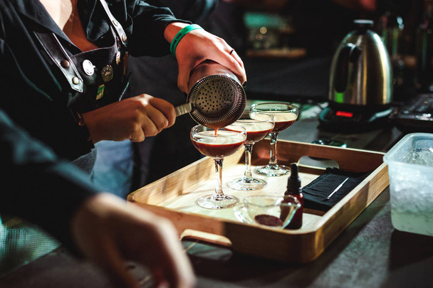 championship among coffee houses, members of teams show barista's skill, prepare drinks, teamwork. pours drink into glasses - Φωτογραφία, εικόνα