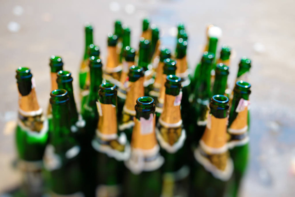 lots of empty bottles of sparkling wine on a blurry background. - Photo, Image
