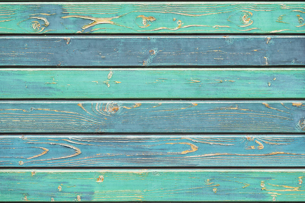 Texture of old wooden fence in turquoise green shades, hues. Rustic natural wooden planks, cracks, scratches for background, copy space - Photo, Image