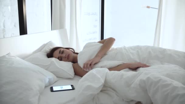 Alarm Clock On Phone. Woman Sleeping In Bed With White Linens - Filmati, video