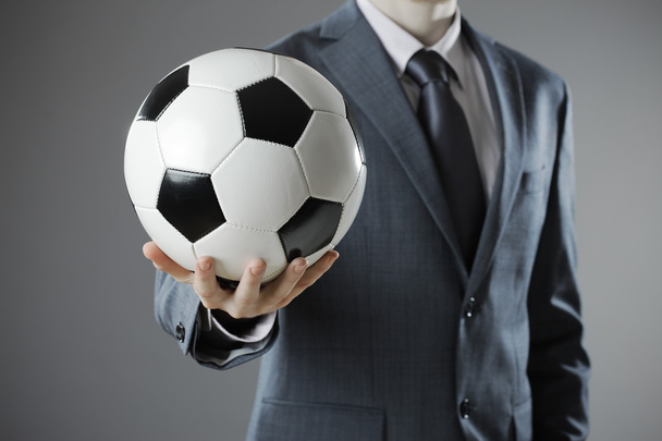 Elegant businessman holding a soccer ball - Фото, зображення