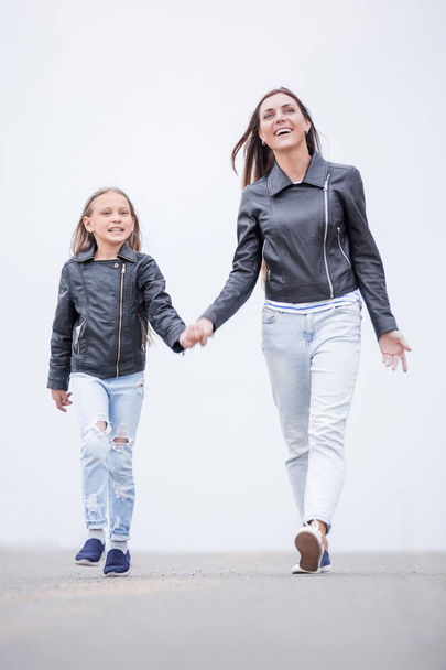 in full growth.happy mother and daughter walking togethe - Фото, изображение