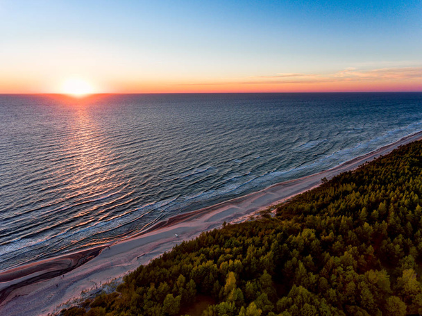 Drone image. aerial view of red sunset in the sea beach. shore line. baltic sea at dust - vintage retro look - Foto, immagini