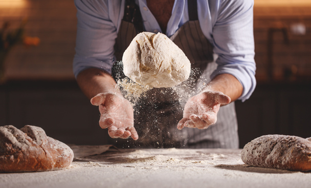  hands of the baker's male knead doug - Фото, изображение