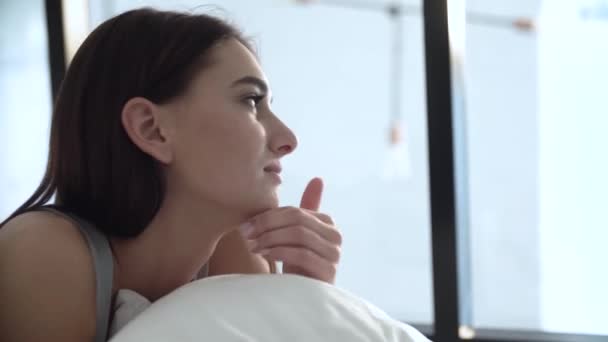 Beautiful Woman Hugging Pillow And Looking In Window - Filmati, video