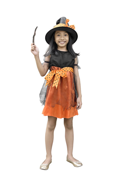 Portrait of asian little girl with witch costume and magic wand isolated over white background - Fotó, kép
