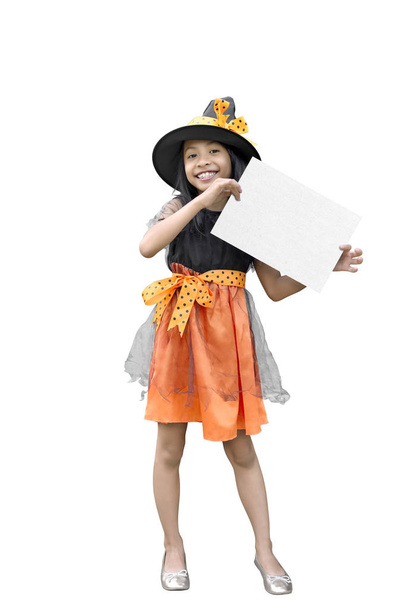 Portrait of asian girl in a witch costume holding copy space isolated over white background - Fotó, kép