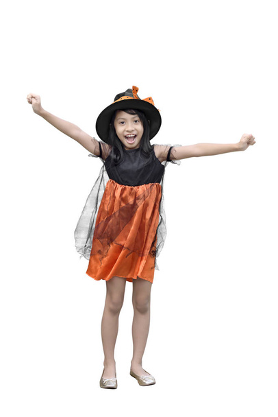Portrait of asian girl in witch costume and hat standing isolated over white background - Fotó, kép
