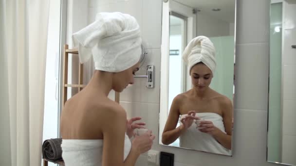 Face Skin Care. Woman Applying Cream On Skin At Bathroom - Metraje, vídeo