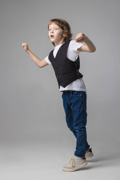 child emotionally posing on camera in the Studio on a white background - Fotó, kép
