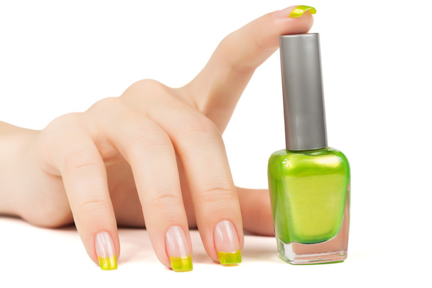woman's hand with a bottle of green nail polish - Фото, зображення