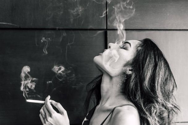 Fashion portrait of  beautiful woman sexy slim body smoking cigarette - Фото, изображение