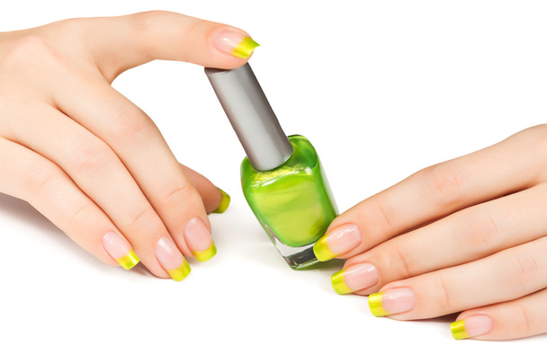 Woman's hand with a bottle of green nail polish - Φωτογραφία, εικόνα