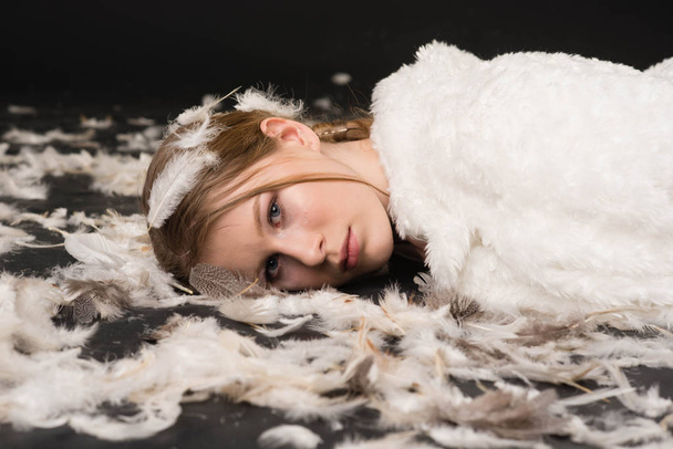 blonde girl, angel in white lying on the floor  - Photo, Image