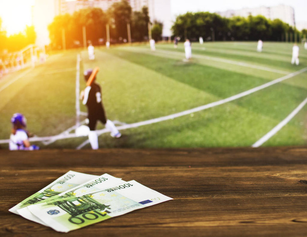 Euro money on the background of the TV on which show the sports game softball, sports betting, euro - Fotoğraf, Görsel