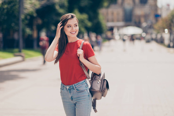 Attractive brunette girl with a backpack went for a walk, lookin - Фото, изображение