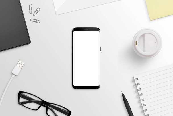 Phone with round edges on white desk. Isolated screen for app or web site presentation mockup. Flat lay. Top view. - Foto, Imagem