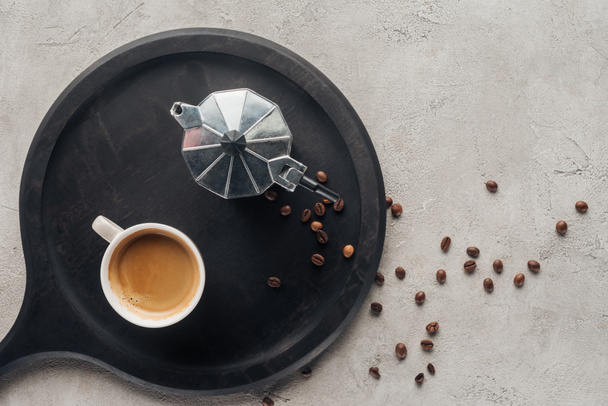 top view of cup of coffee and moka pot on concrete surface - Photo, Image