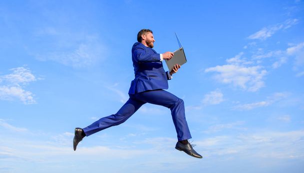 Internet connection so fast. Boost speed online. Businessman laptop satisfied quality. Man with laptop jump or fly in air blue sky background. Excellent internet provider raise up quality connection - Фото, зображення