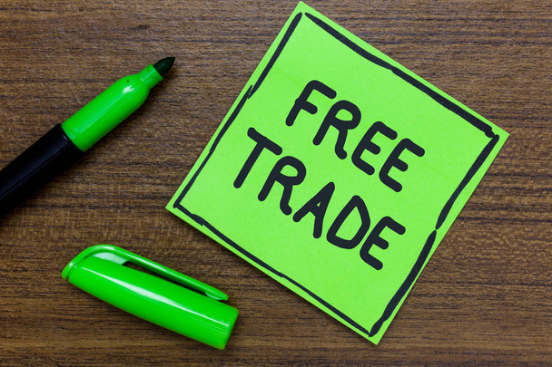 Conceptual hand writing showing Free Trade. Business photo showcasing The ability to buy and sell on your own terms and means Green Paper Communicate ideas Marker Wooden background - Photo, Image