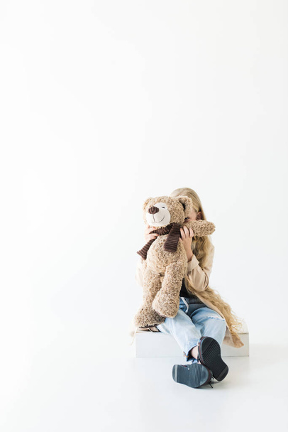 adorable little child hugging teddy bear isolated on white - Fotografie, Obrázek