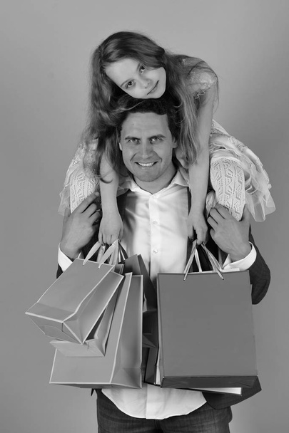 Girl and man with happy faces hold shopping bags - Fotoğraf, Görsel