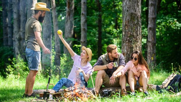 Camping and hiking. Company friends relaxing and having snack picnic nature background. Great weekend in nature. Halt for snack during hiking. Company hikers relaxing at picnic forest background - Photo, image