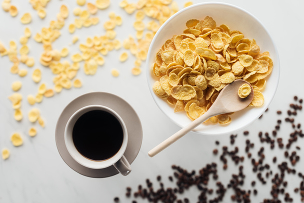 top view of bowl of dry cereal breakfast with cup of coffee on white - Photo, Image