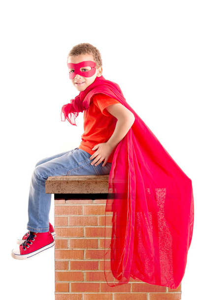little boy pretending to be a superhero isolated on white background - Fotografie, Obrázek