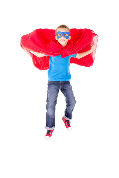 little boy pretending to be a superhero isolated on white background - Foto, Imagem