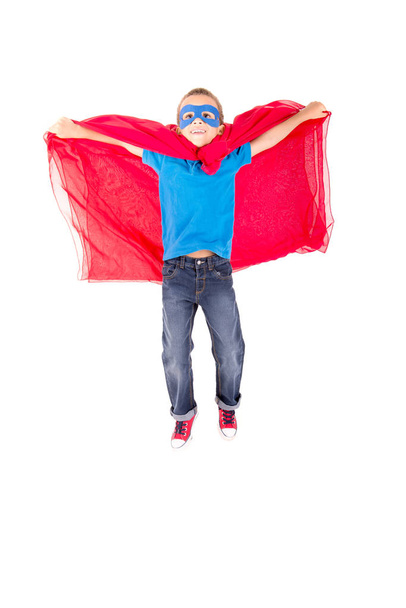 little boy pretending to be a superhero isolated on white background - Foto, afbeelding