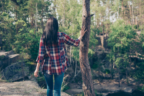 Rear back view of young nice sporty brunette girl in wild wood,  - Фото, зображення