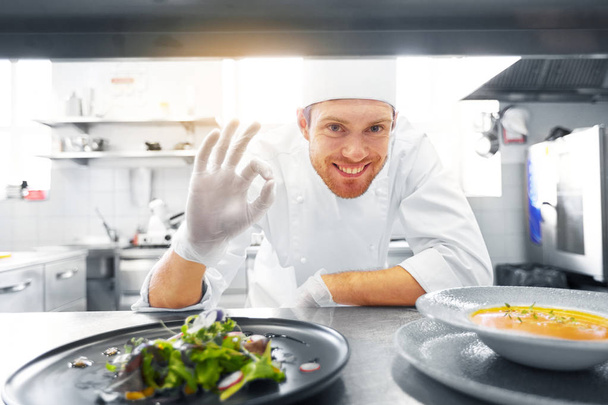 happy male chef cooking food at restaurant kitchen - Photo, image