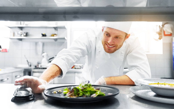 happy male chef cooking food at restaurant kitchen - Zdjęcie, obraz
