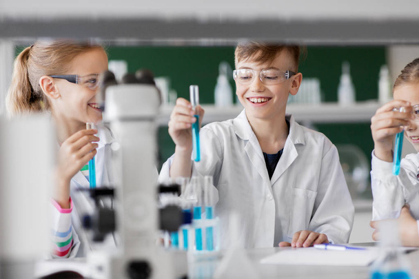 kids with test tubes studying chemistry at school - Fotó, kép