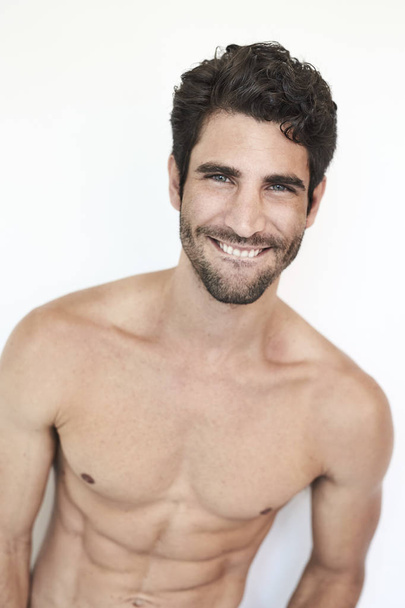 Semi-dressed man smiling to camera, studio - Foto, Imagen