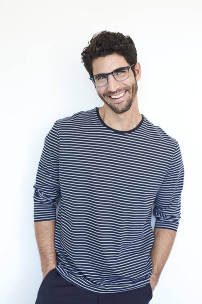 Guy in striped top and glasses, smiling - Zdjęcie, obraz